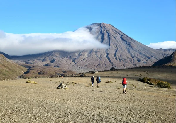 Cloud covering a volcanic cone with people enjoying the view