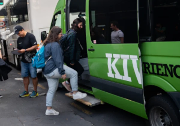 People loading into a Kiwi Experience van