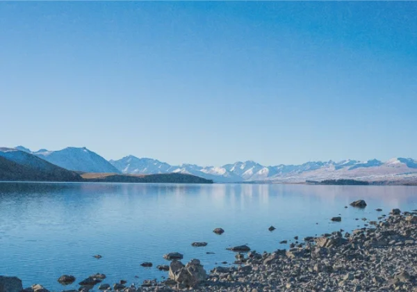 Lake with snowy mountain range in the background