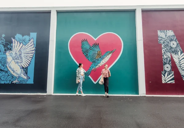 Urban art of a small bird in a heart 