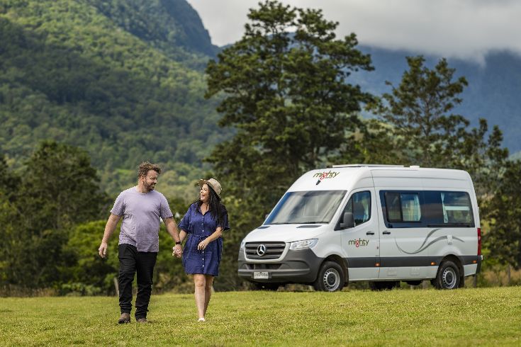 Couple hanging out at their campervan