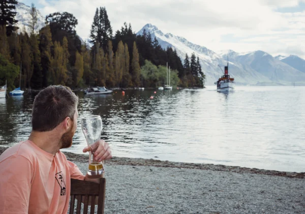 Man looking over at a boat on a lake