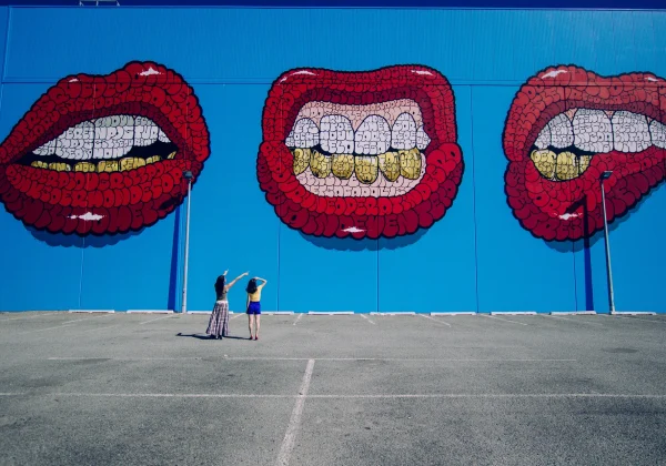 Urban street art of lips and teeth made of of words