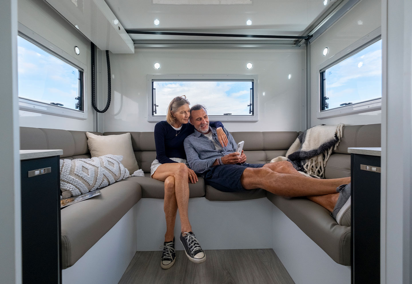 Couple lying together on a lounge, relaxing and enjoying a cozy, comfortable space