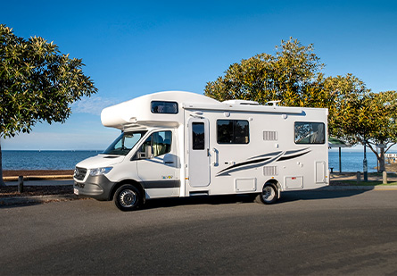 Talvor Euro Deluxe Motorhome parked in front of a picturesque blue ocean in a beachside carpark.