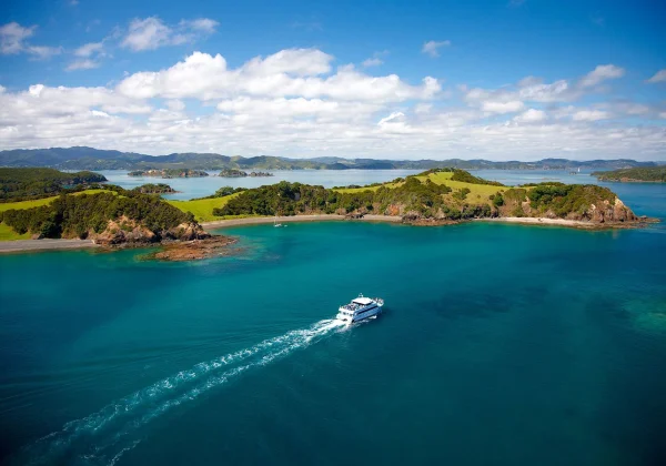 Ferry travelling around islands in a blue ocean