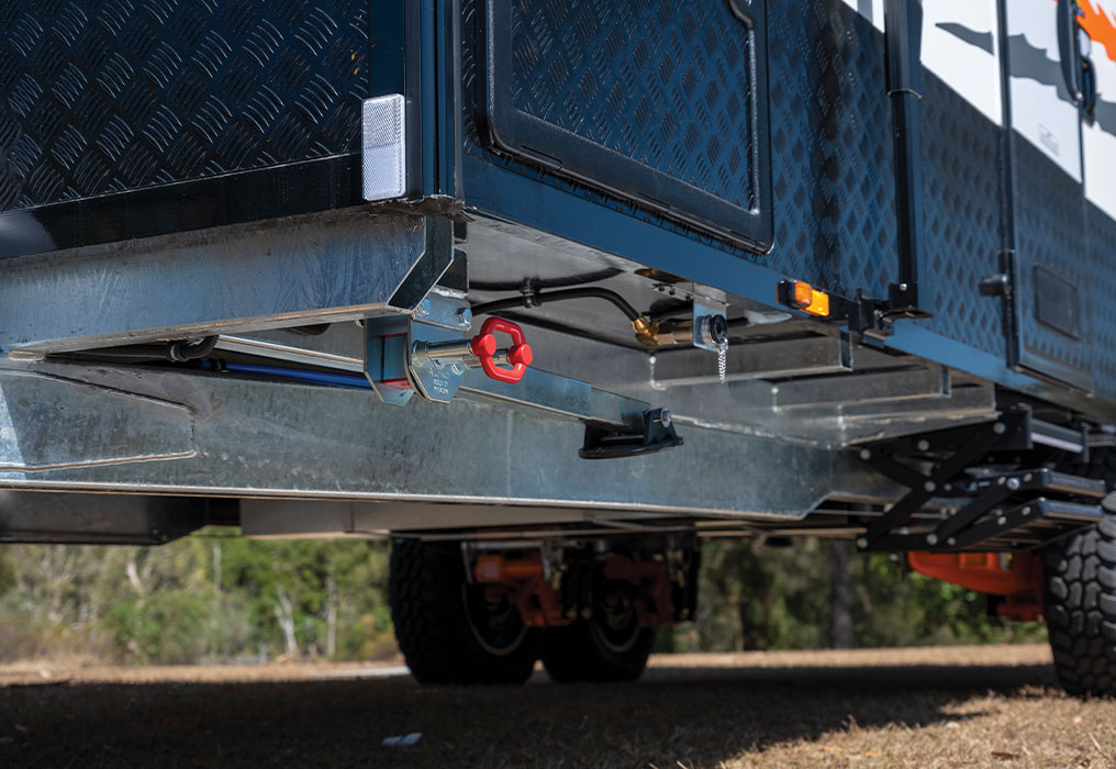 Close-up view of an Australian made steel chassis showcasing robust and intricate engineering details, with a smooth and polished metal finish.