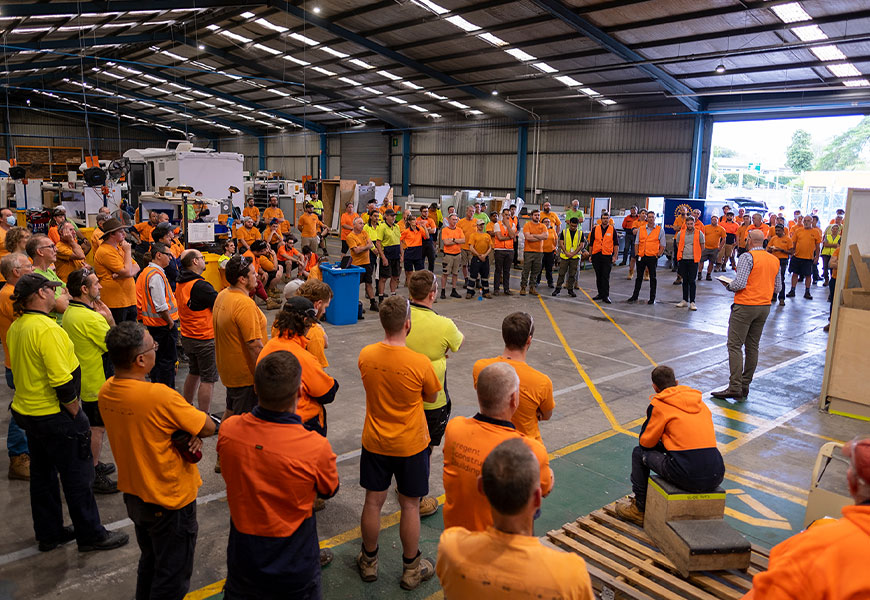 Interior of the Winnebago manufacturing warehouse at Apollo motorhomes, Brisbane Australia. Workers are having a meeting.