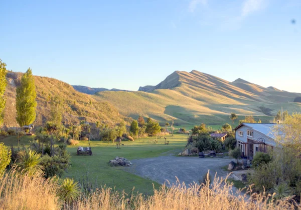 Grass covered hill with a lodge at the base
