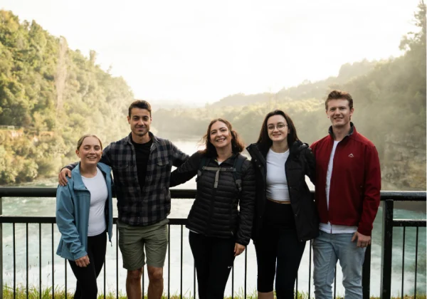 Group standing on a viewing platform over the Huka falls