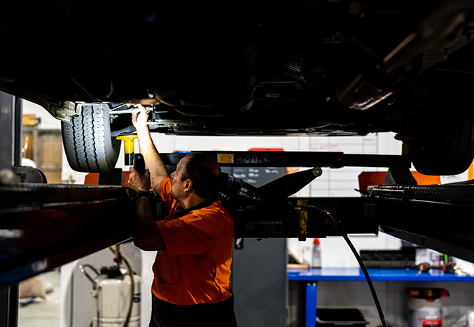 Service Technician Working on the Underside of a Motorhome