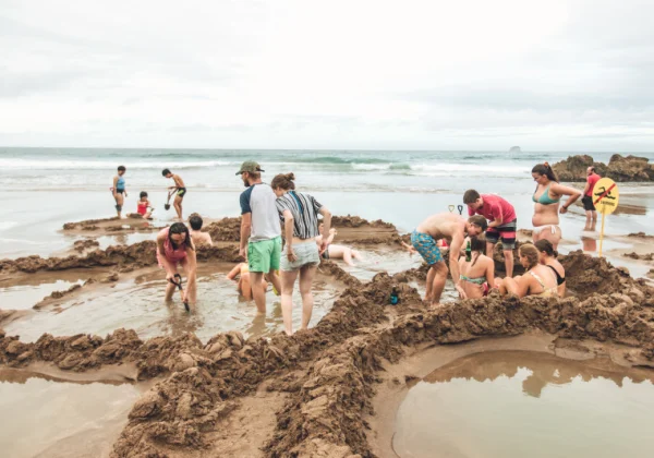 Digging sand pools in the beach with the naturally warm water