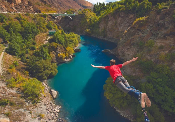 Aerial view of someone bungy jumping over a river