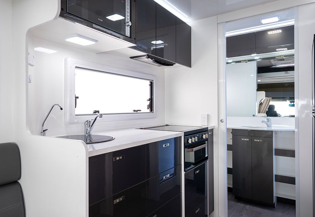 Modern kitchen with a sink and laminated benchtops, showcasing sleek and durable surface finishes