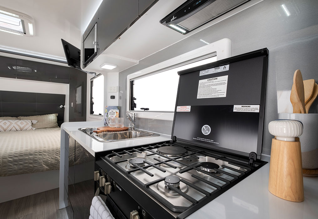 Interior featuring a washing machine, 188L fridge, and stove with grill, highlighting essential appliances for a well-equipped living space