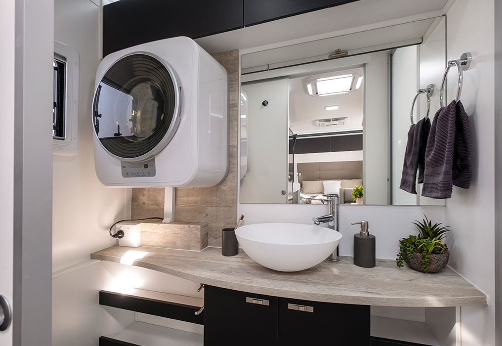 Full-size ensuite with a flushing toilet and 12V fan, showcasing modern amenities and ventilation features