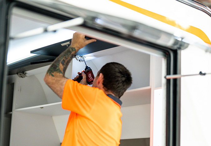 Service Technician Working on the Interior Cabinetry