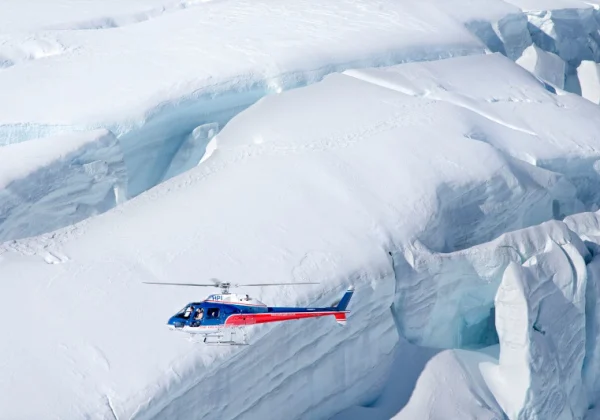 Helicopter with a full snow covered glacier background