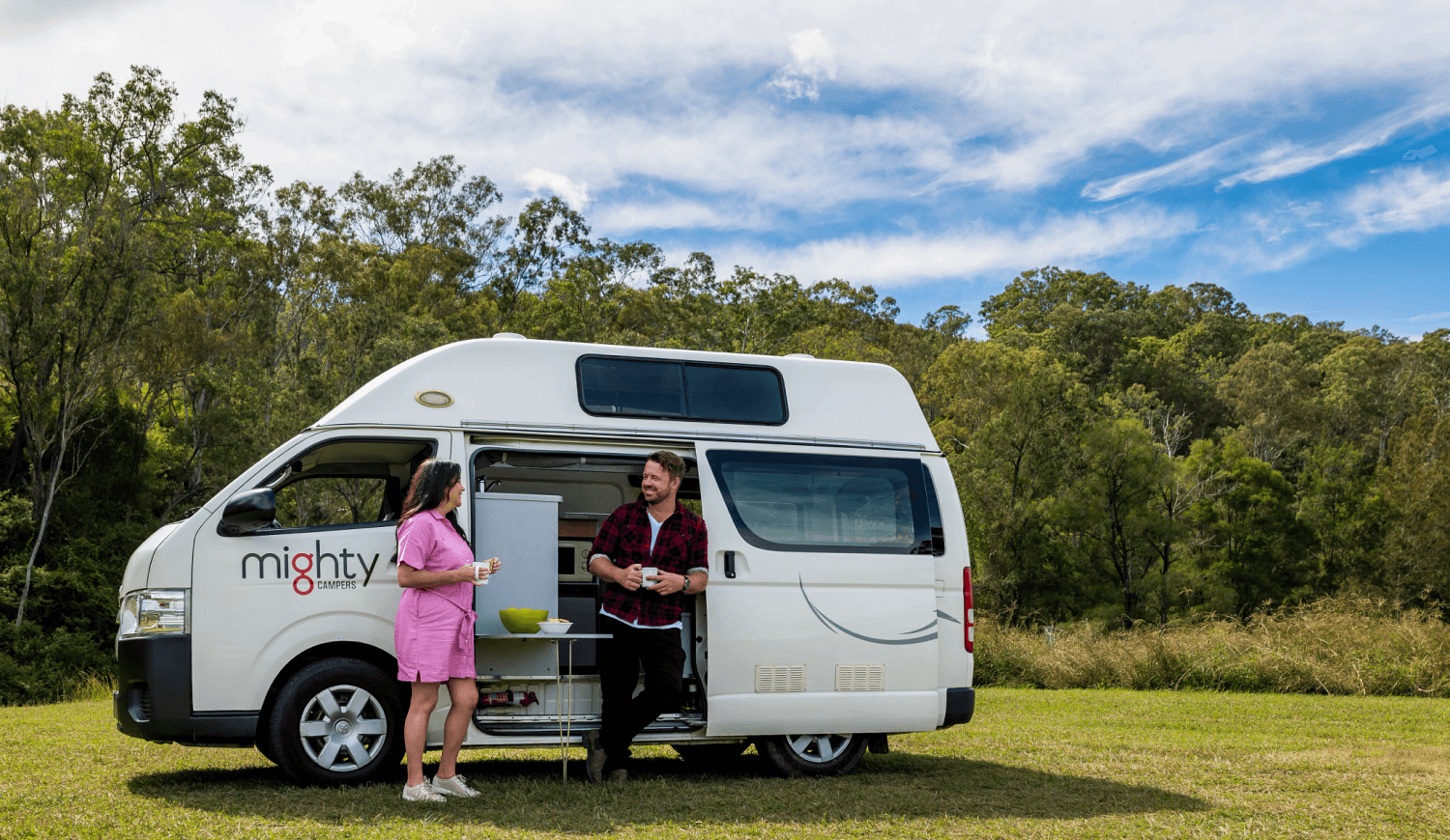 Couple hanging out at their campervan
