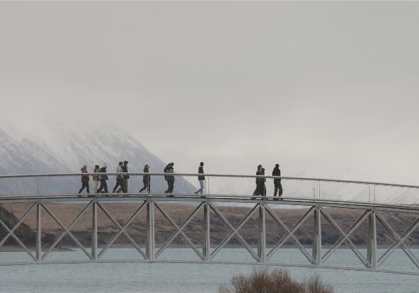 Crossing a bridge with fog covered mountains