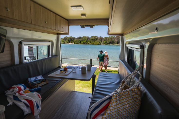 Campervan by the beach with a couple Campervan by the beach with a couple