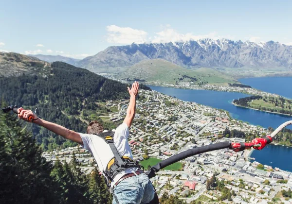 Person Bungy jumping with Queenstown & lake in the background