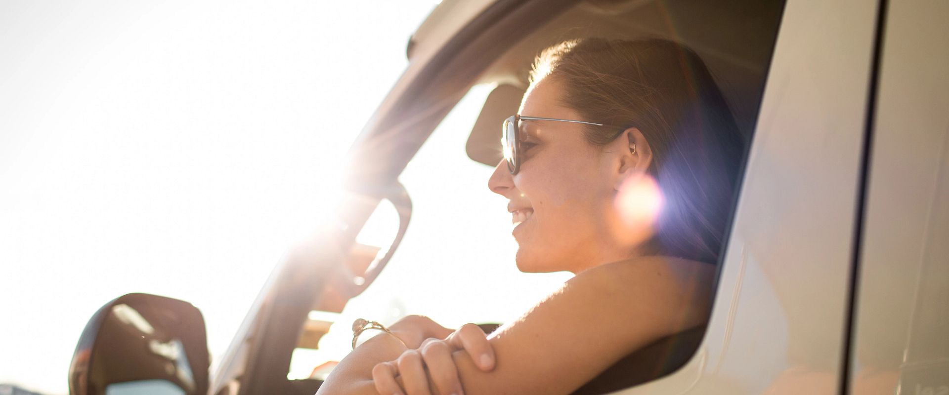 Woman leaning out of window in vehicle