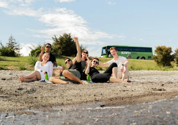 6 people having a picnic on the side of a lake