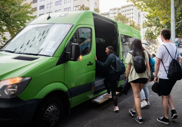Travellers loading into a kiwi experience van