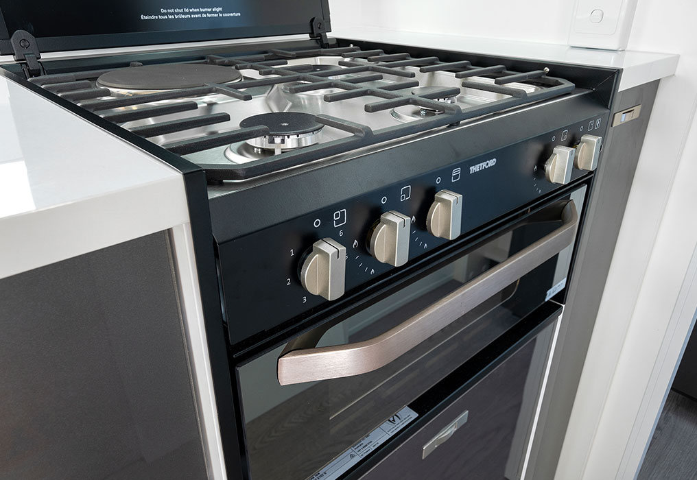 Interior featuring AC, stove, fridge, microwave, and stereo, showcasing a fully equipped and modern living space.