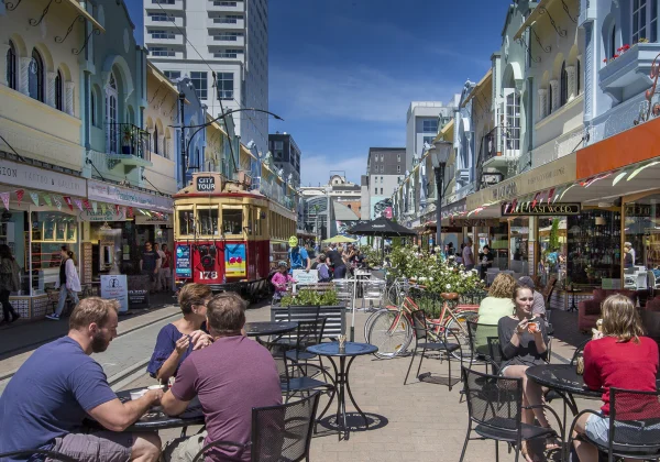 Urban scene of a cafe with a tram approaching
