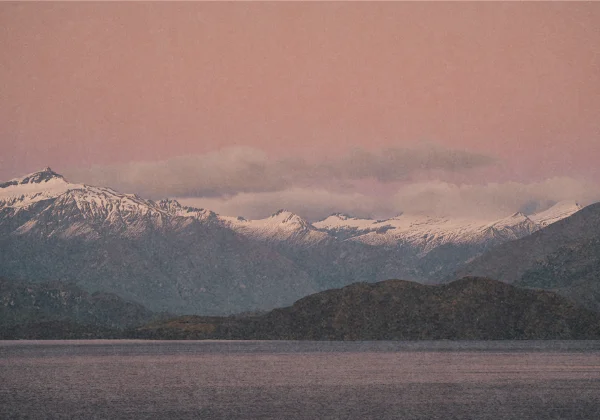 Sunsetting over snow covered mountain range